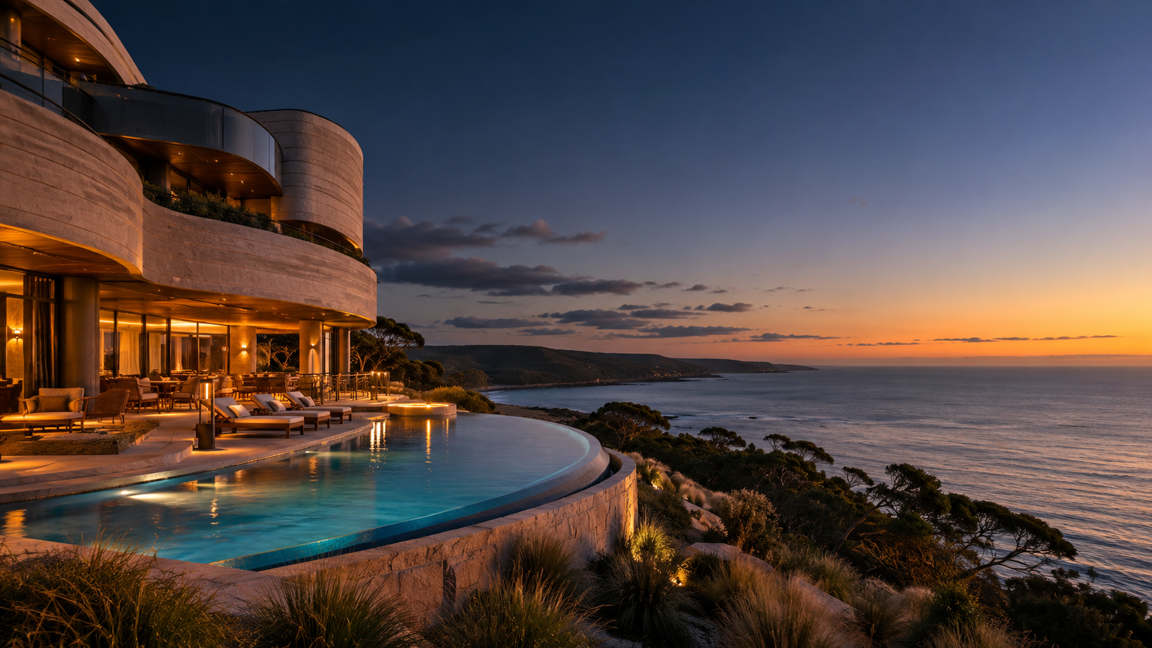 Contemporary Australian coastal hotel with sandstone terraces, native trees and an infinity pool at sunset